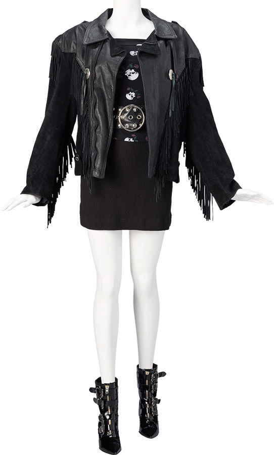 Christina Applegate "Kelly Bundy" Black Leather Motorcycle Jacket with Fringe, Suede Purse, Cotton Top with Skull and Roses, Ribbed Skirt, Belt with Large Studs, Stiletto Boots, and Crucifix Jewelry from Married with Children (Fox TV, 1987-1997).